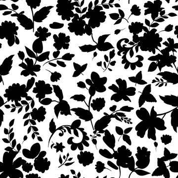 Abstract seamless pattern with isolated black flowers silhouettes on white background.