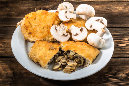Fried chicken kiev from chicken breast stuffed with champignons.