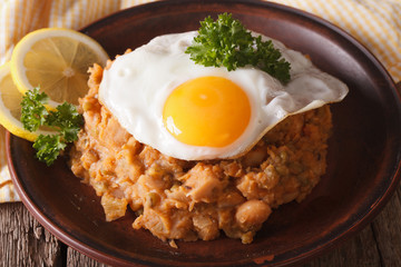 Arabic Breakfast: ful medames with a fried egg close-up. horizontal
