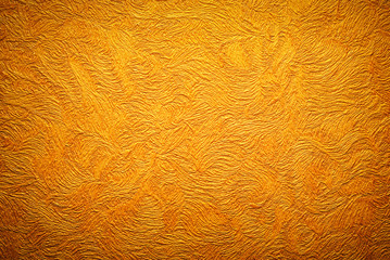 Gold background texture. Wallpaper on the wall.