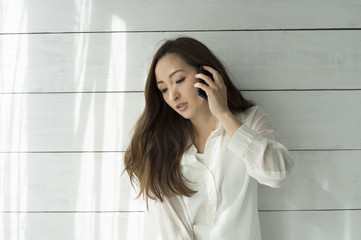Beautiful Asian woman is talking on smartphone