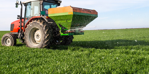 Fototapeta premium tractor fertilizing in field