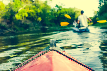 nose of canoe floating behind rower © Ievgen Skrypko