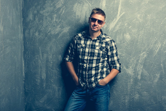 man in sunglasses and plaid shirt