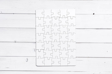 white completed puzzle on white wooden table