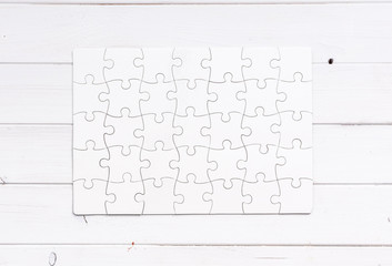 white completed puzzle on white wooden table