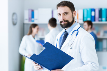 Confident doctor posing in the office
