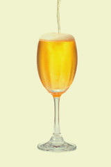 Pour beer into a glass with a white backdrop.