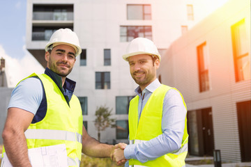 Worker and architect watching some details on a construction