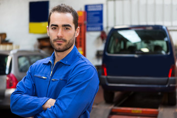 Young attractive mechanic working at the garage