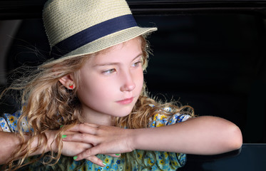 Young girl traveling by car