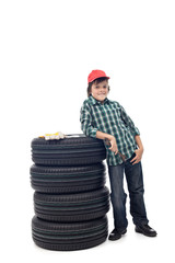 Young boy with a set of car tires