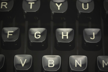 Close up of lettered keys on an old typewriter. Vintage filter a