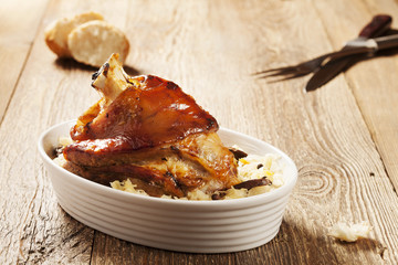Roast pork knuckle served with boiled cabbage, bread, horseradis