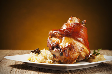 Roast pork knuckle served with boiled cabbage, bread, horseradis