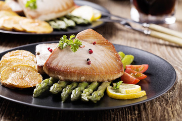 Grilled tuna steak served on asparagus with roasted zmieniakami