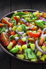 Salad with avocado, tomato, paprika, red onion and corn