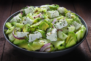 Salad with avocado, cucumber,cheese and red onion