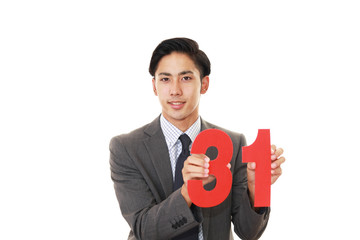 数字を持つ笑顔のビジネスマン