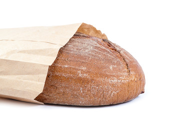 Loaf of bread in a eco-friendly paper bag.