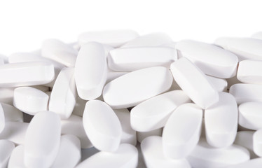 Fototapeta na wymiar Heap of white pills on a white