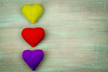heart crocheted from threads, red, white, blue, purple, yellow,