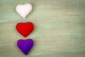 Fototapeta premium heart crocheted from threads, red, white, blue, purple, yellow,
