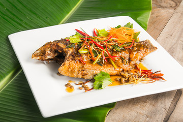 fried fish with fresh herbs and sweet spicy sauce