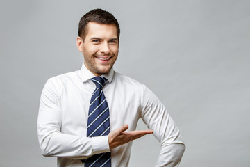 Handsome stylish businessman on grey background