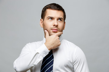 Handsome stylish businessman on grey background