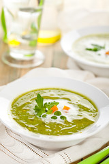 Green pea soup in bowls.