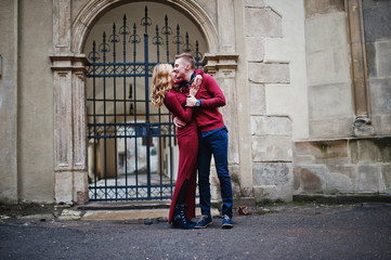 Young beautiful stylish fashion couple in a red dress in love st