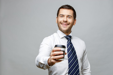 Handsome stylish businessman on grey background