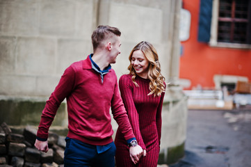 Young beautiful stylish fashion couple in a red dress in love st