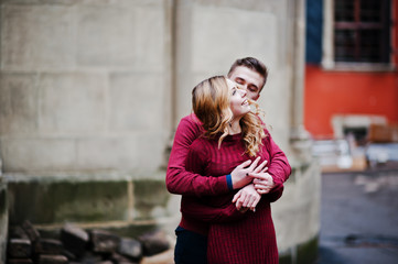 Young beautiful stylish fashion couple in a red dress in love st