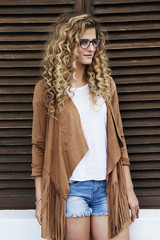 Fototapeta premium Beautiful woman in spectacles and suede jacket