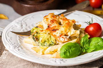 Baked pasta with broccoli, cauliflower, cheese and bechamel sauc