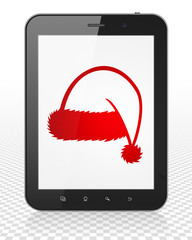 Holiday concept: Tablet Pc Computer with Christmas Hat on display