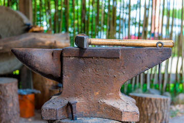 heavy hammer on the anvil in the forge close up