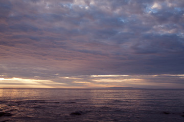 Naklejka na ściany i meble Clouds at sunset over the sea. The Sea of Okhotsk. Peninsula Kony. Magadan Region. Russia.