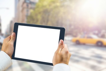 Composite image of man using tablet pc