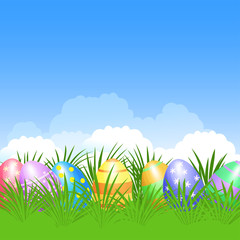 Easter background and colorful Easter eggs in green grass 