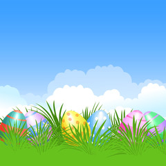 Fototapeta na wymiar Easter background and colorful Easter eggs in green grass