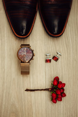 Groom's morning. Wedding accessories in red colors. Cufflinks, watch, shoes, boutonniere