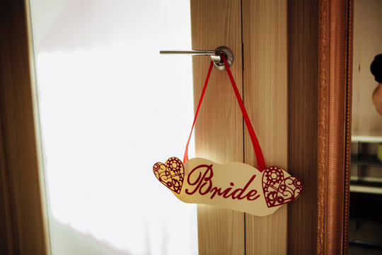 Bride sign hanging on a closed door