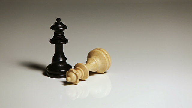 Close up of single hand utting down chess piece for competition or strategy concept