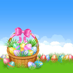 Easter basket and colorful Easter eggs in green grass