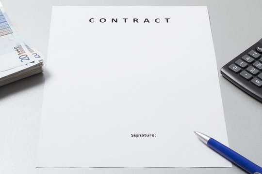 White clean and clear paper sheet with title Contract ready to be signed. There are also a wad of money , Euro banknotes, pen and calculator around it. 