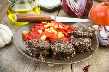 fried peppers and sausage served on wooden