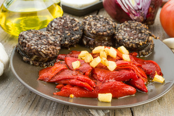 fried peppers and sausage served on wooden